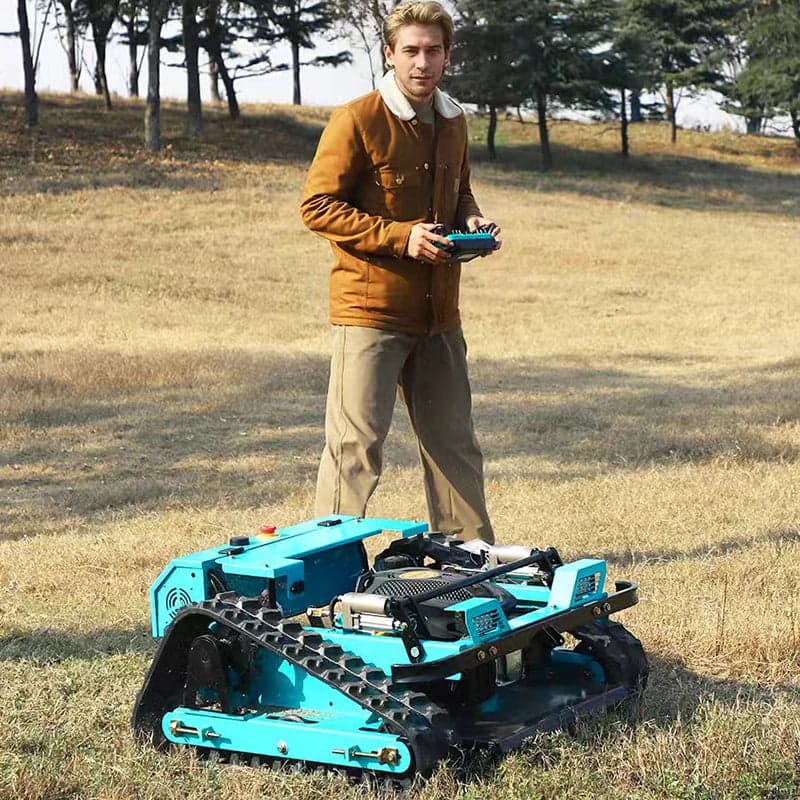 Owner operating the tracked mower from a distance with the handheld remote